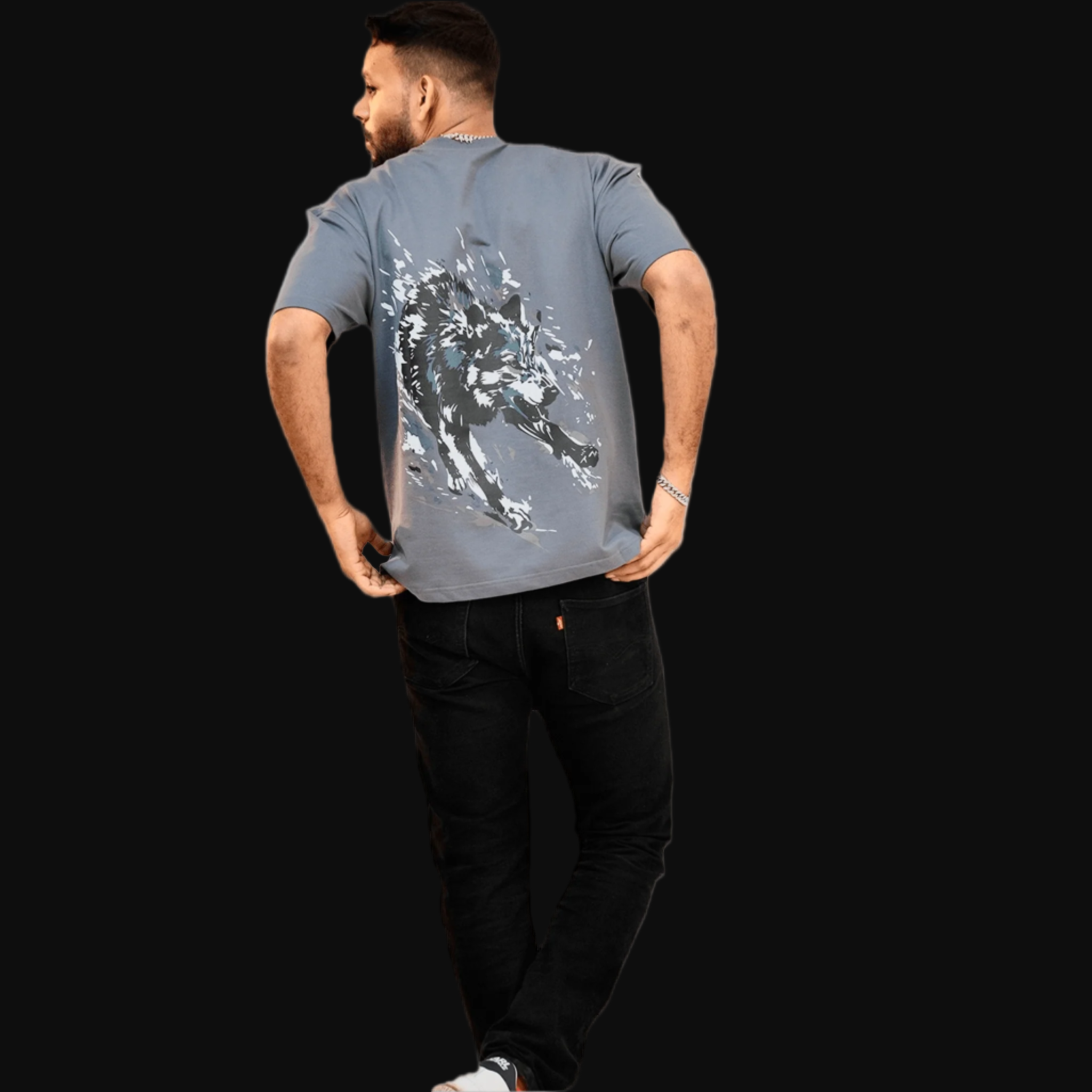 Person wearing a gray t-shirt with a graphic design on the back.
